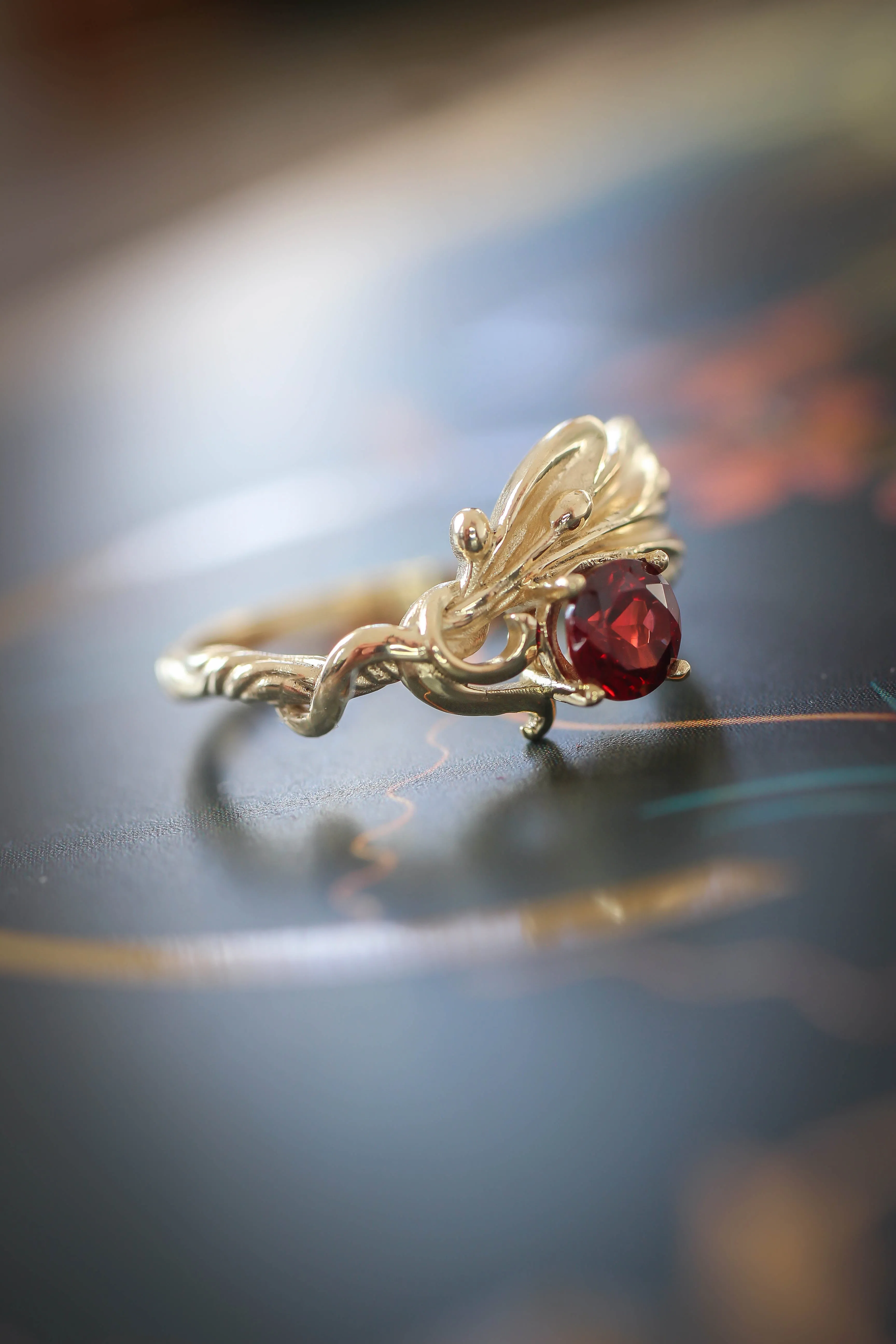 Olive branch ring with ribbon and red garnet