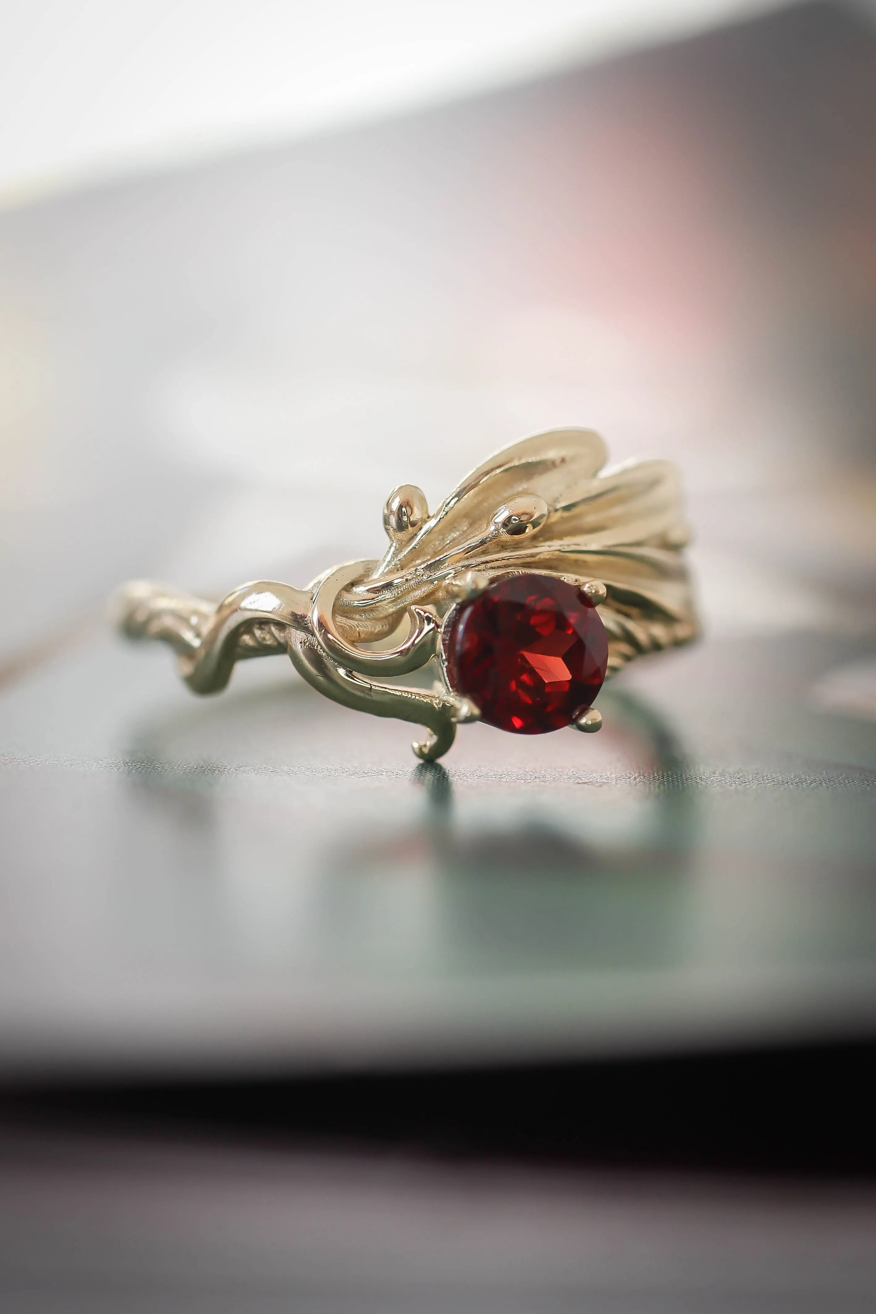 Olive branch ring with ribbon and red garnet