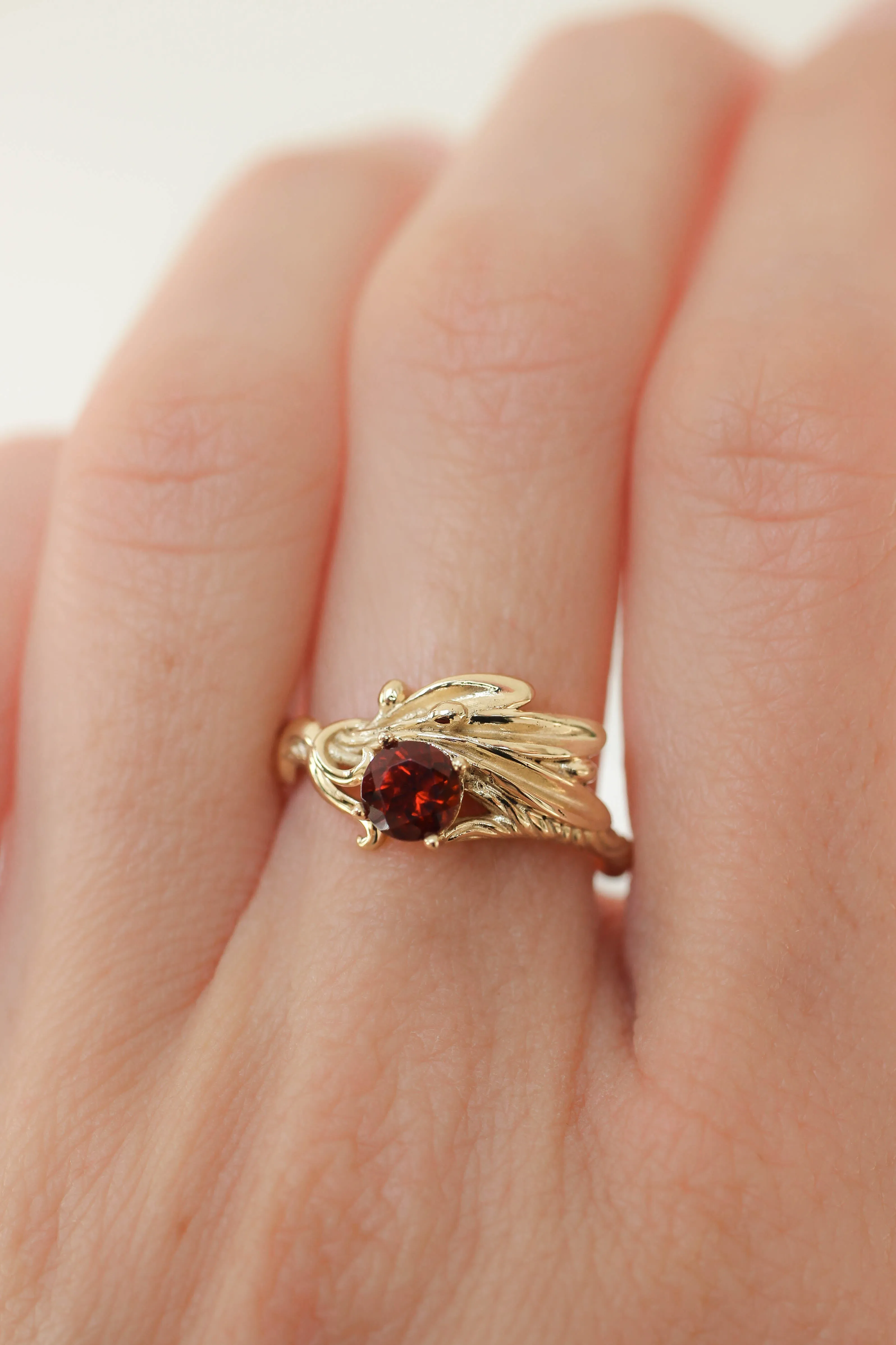 Olive branch ring with ribbon and red garnet